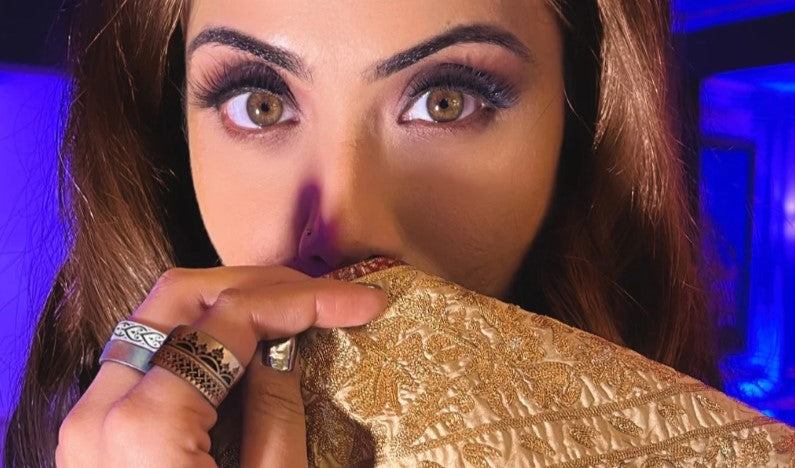 Why does a woman wear a ring on her middle finger?