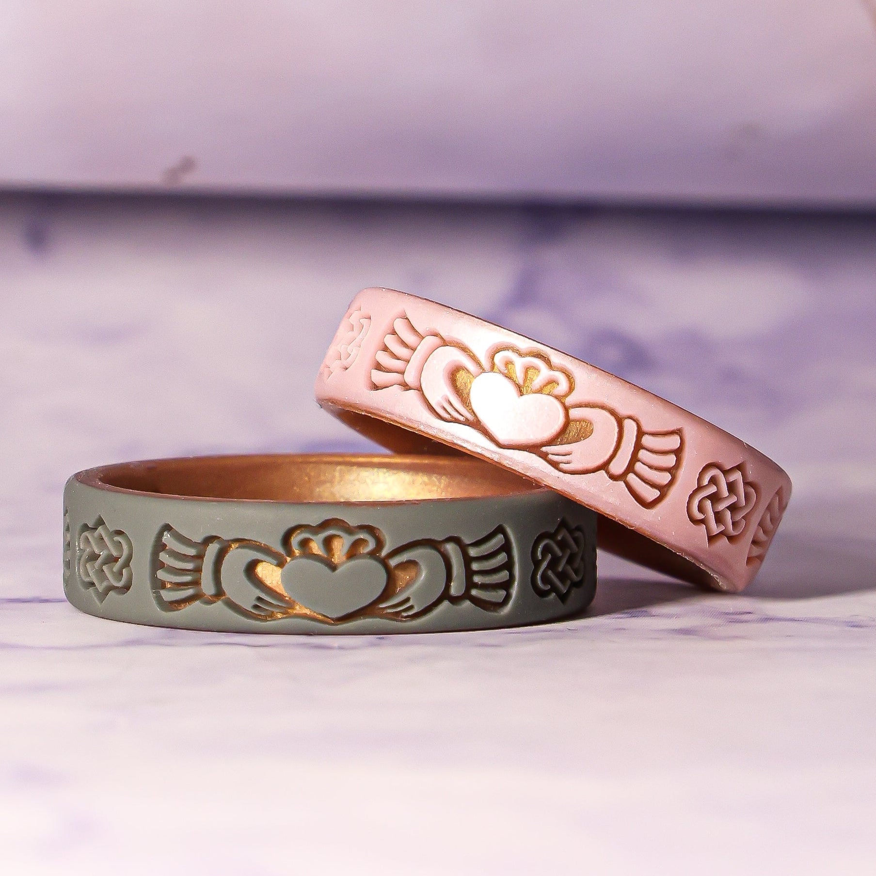 Two rose gold rings with claddagh designs