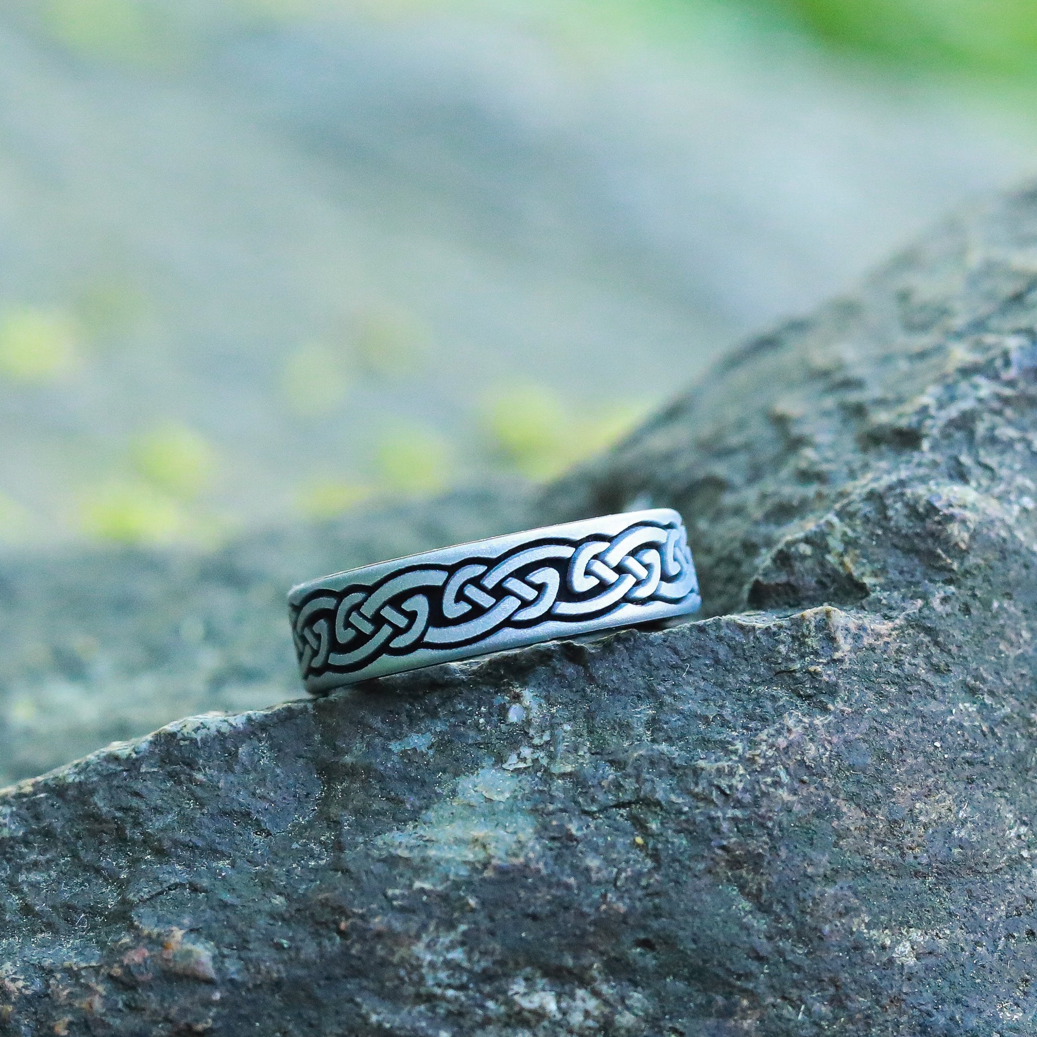 Silver ring with Celtic design on a rock